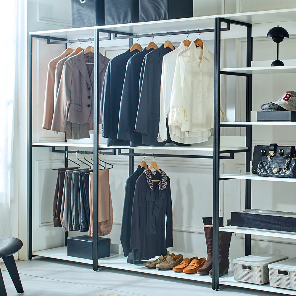 Stylish open closet with neatly hung womens suits and shirts