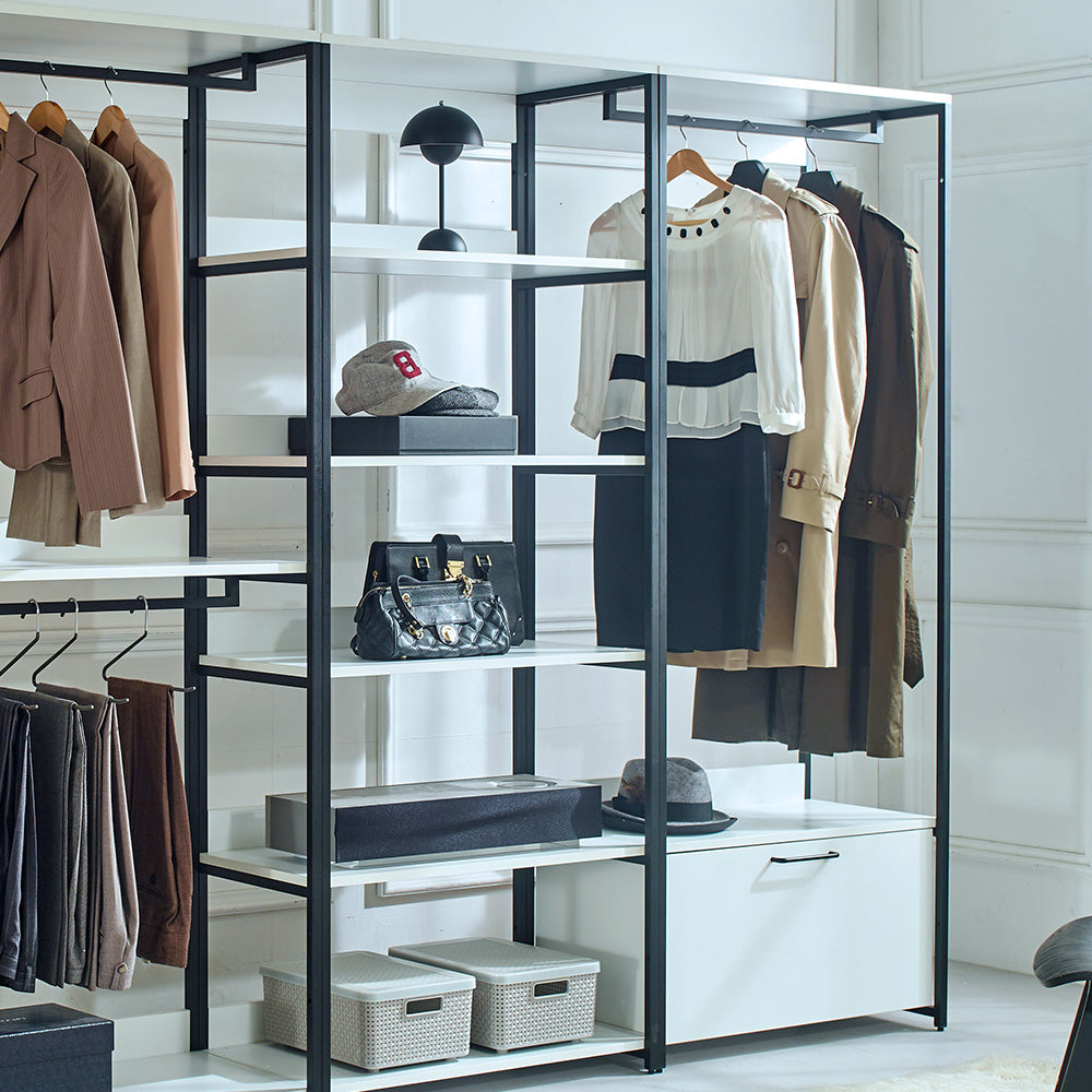 Brown suit jacket and pants on hangers in a modern wardrobe