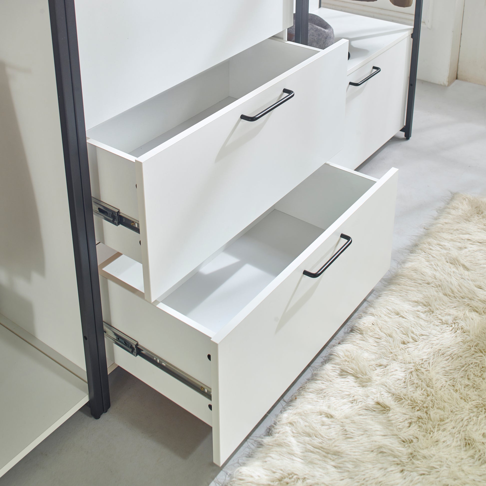 White storage cabinet with two open drawers