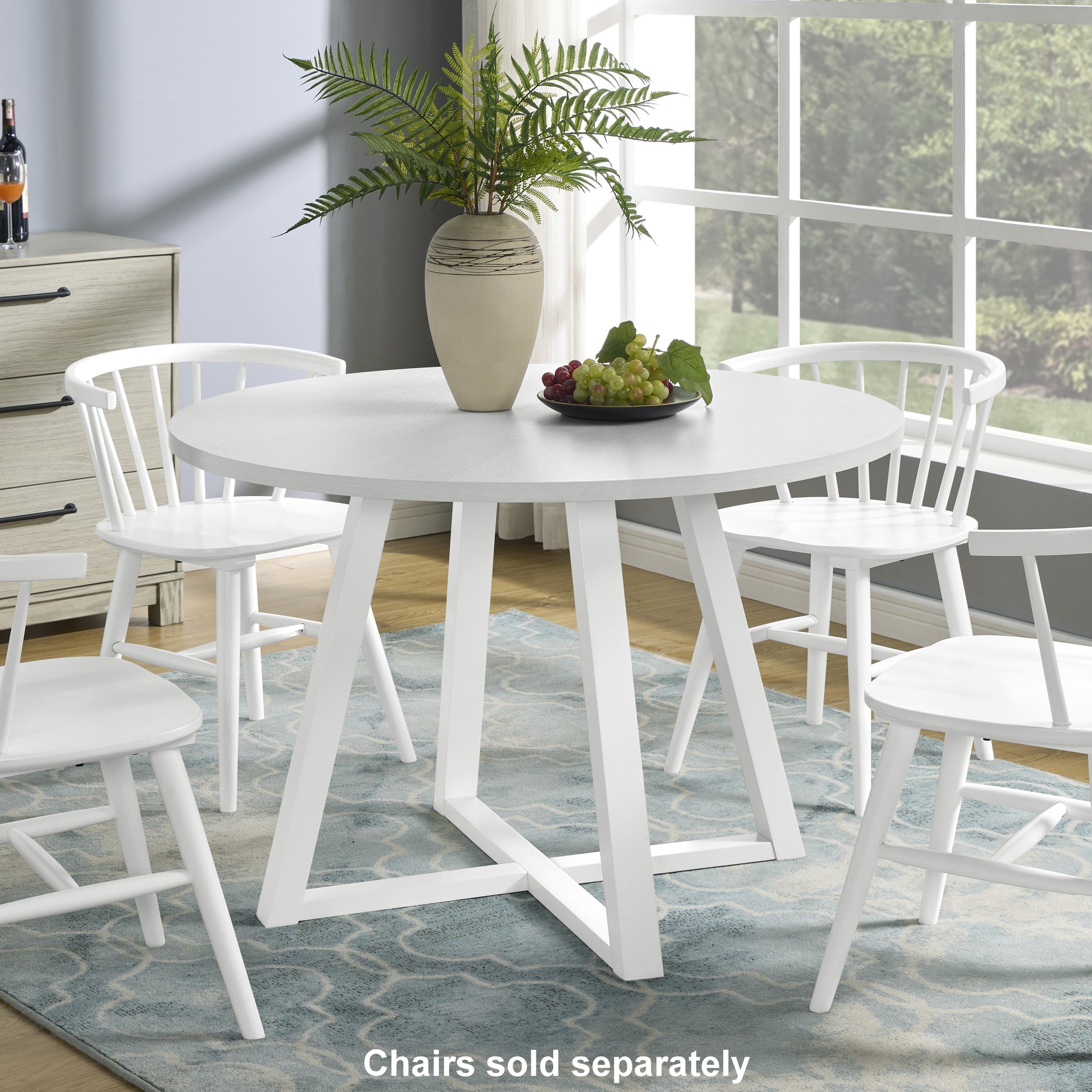 Round white dining table with slatted back chairs