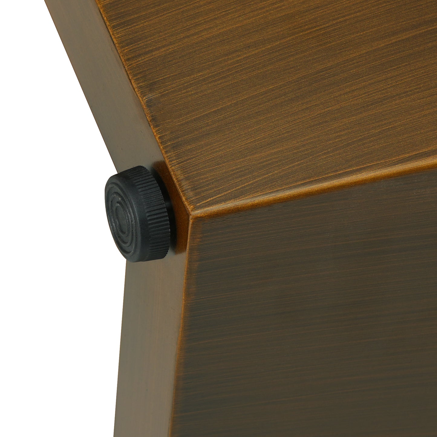 Closeup of brushed bronze metal surface with textured black knob