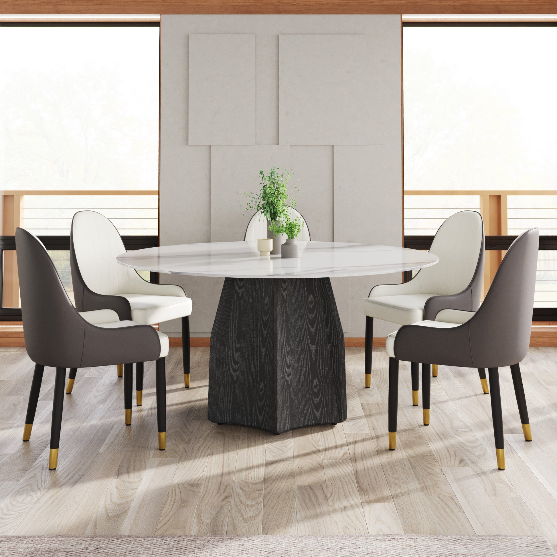 White marble oval dining table with dark wood pedestal base and four upholstered chairs