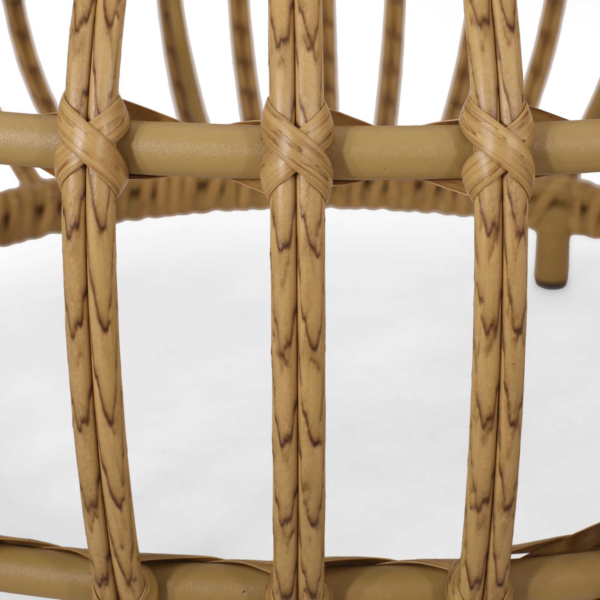 Detail of tan rattan chair frame with intricate weaving