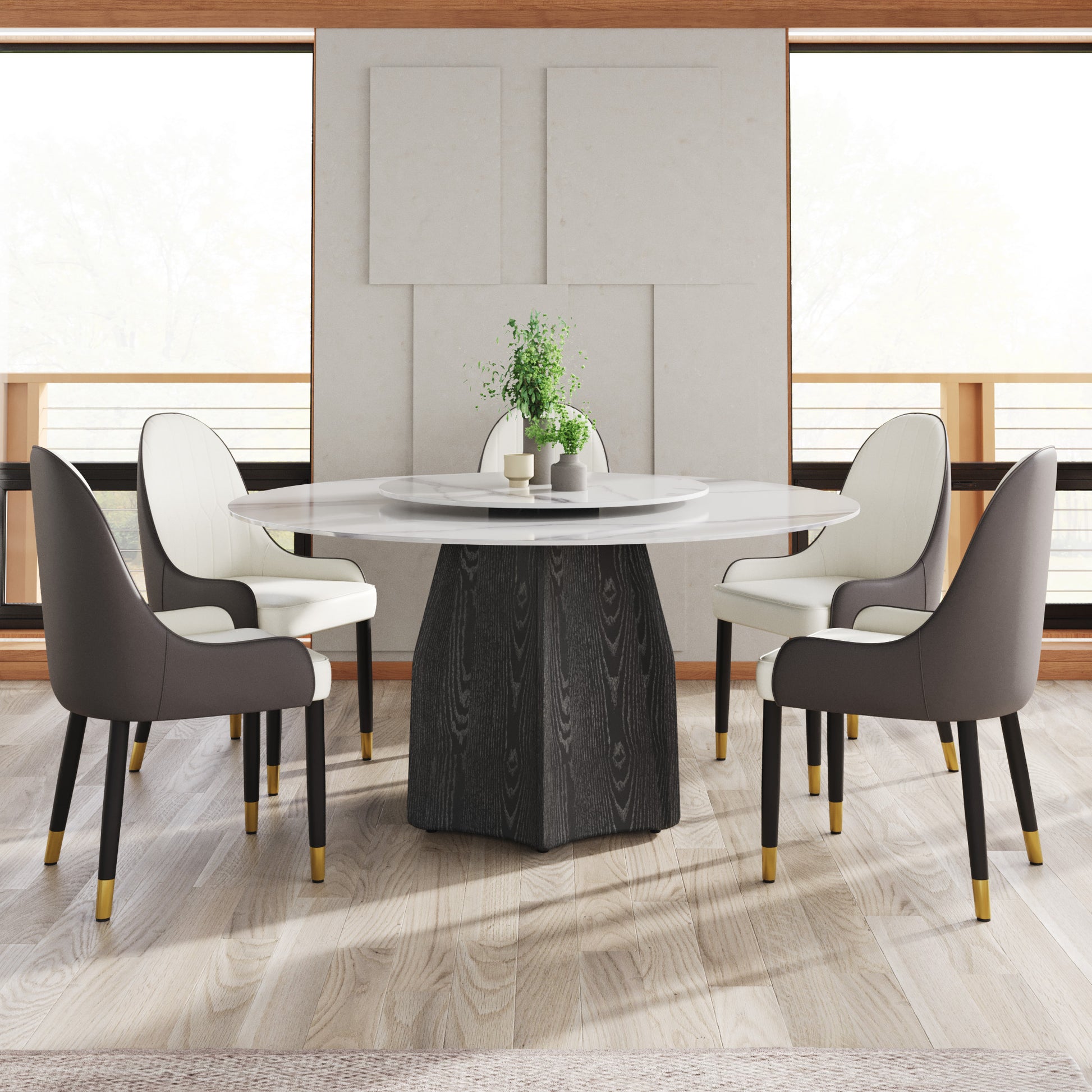 Modern round marble dining table with a dark wood pedestal base and four chairs