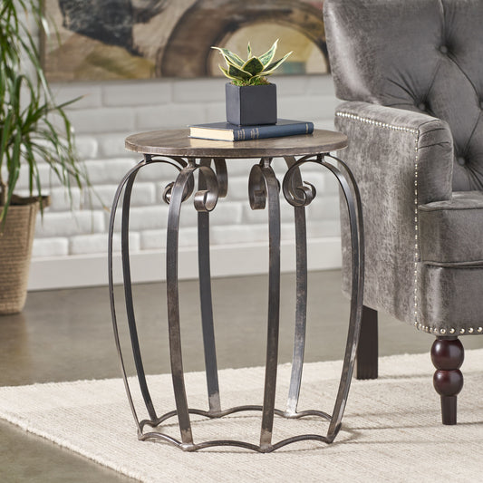 Rustic metal accent table with ornate scrolled legs and a distressed wooden top