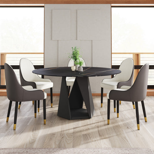 Black marble round dining table with gold veining and four modern upholstered chairs