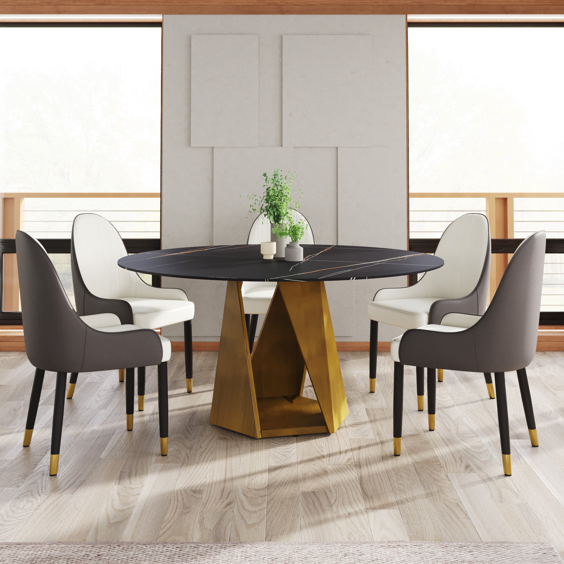Black marble dining table with gold geometric base and white  gray upholstered chairs