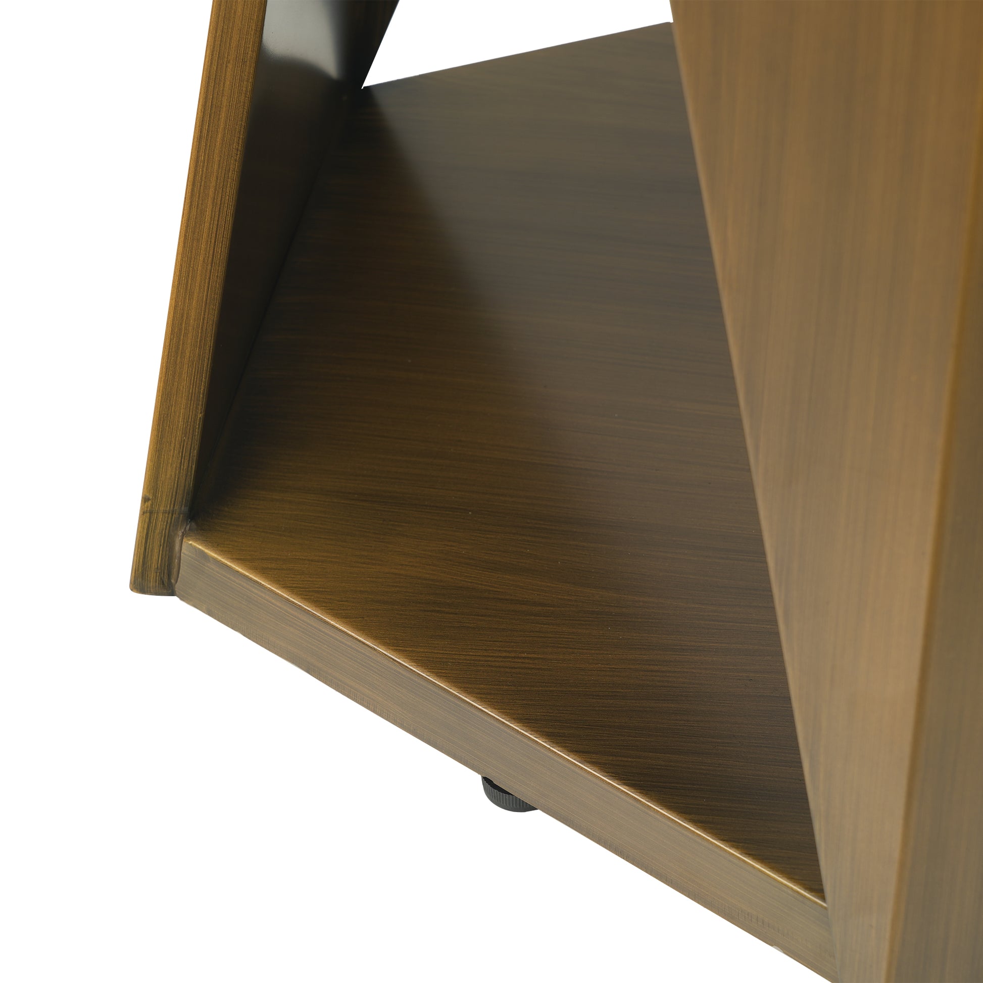 Closeup of a brushed bronze metal shelf with textured wood grain pattern