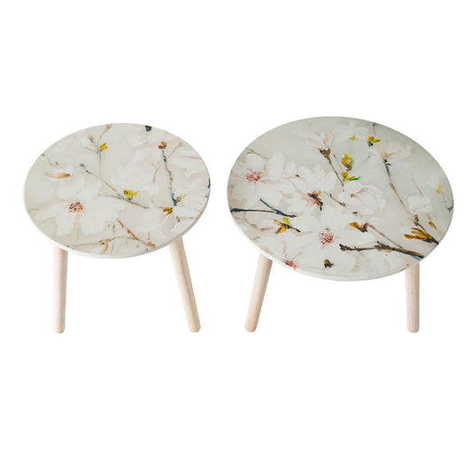 Two round accent tables with delicate white floral print and light wood legs