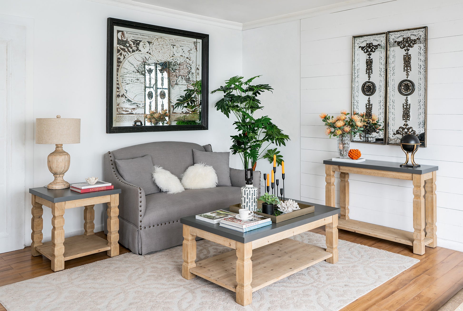 Gray upholstered sofa with decorative tufting and textured accent pillows