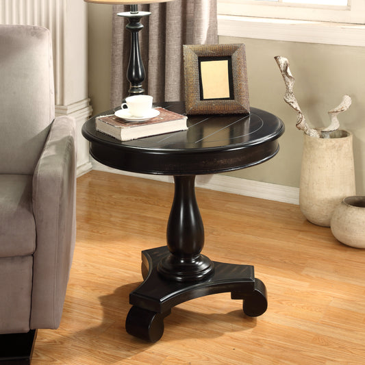 Black round pedestal accent table with decorative base and carved detailing on top