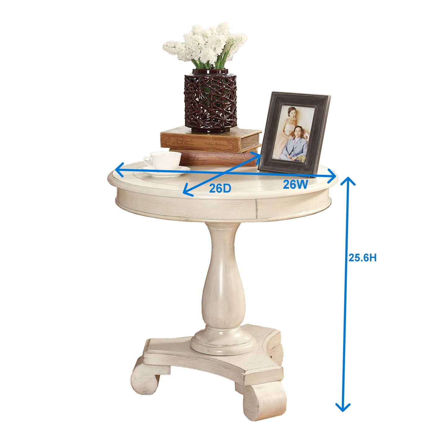 Cream distressed pedestal accent table with a round top Features decorative carved legs and a charming vintage style for your living room
