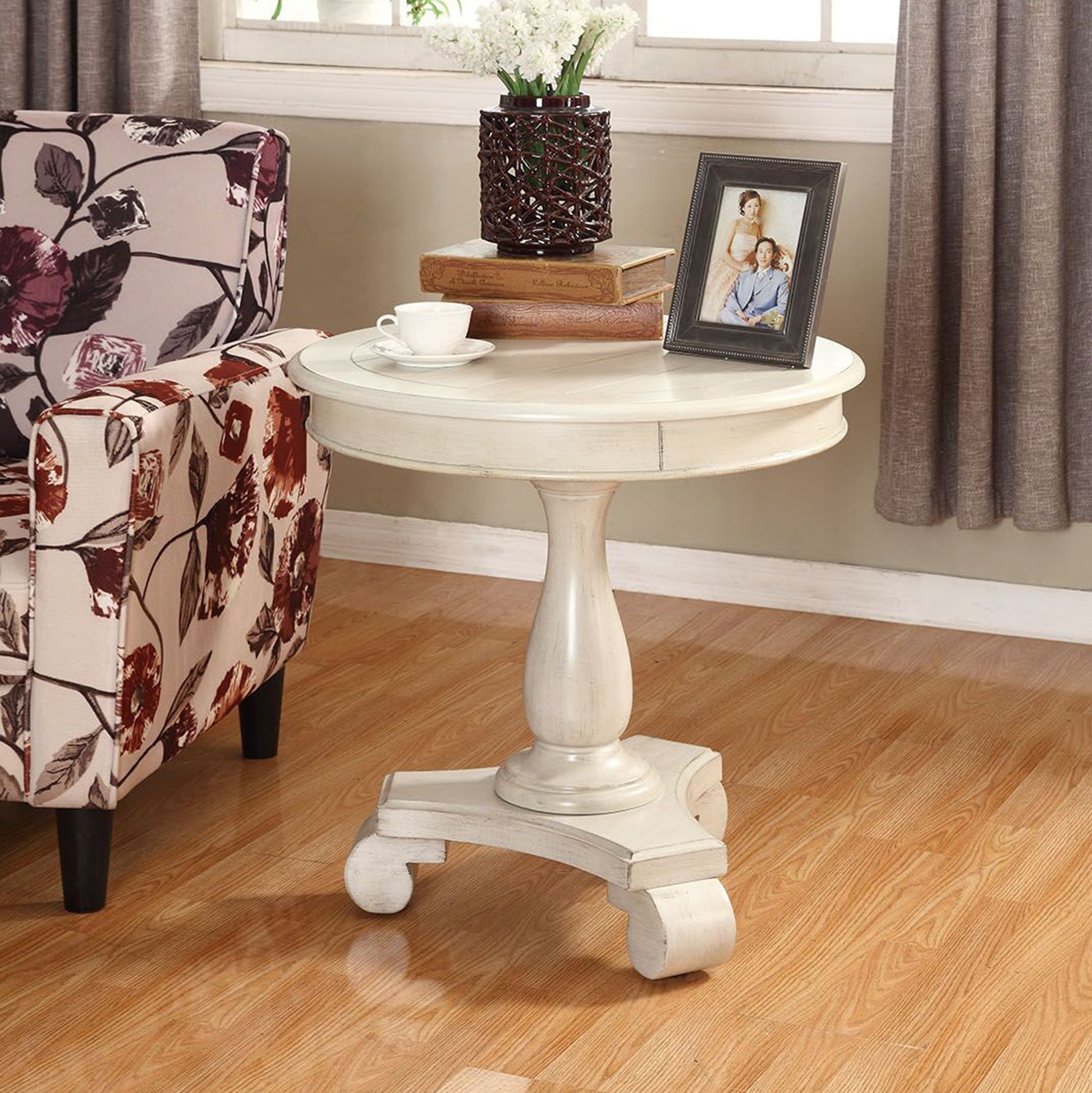 Antique white round pedestal side table with carved details for living room accent