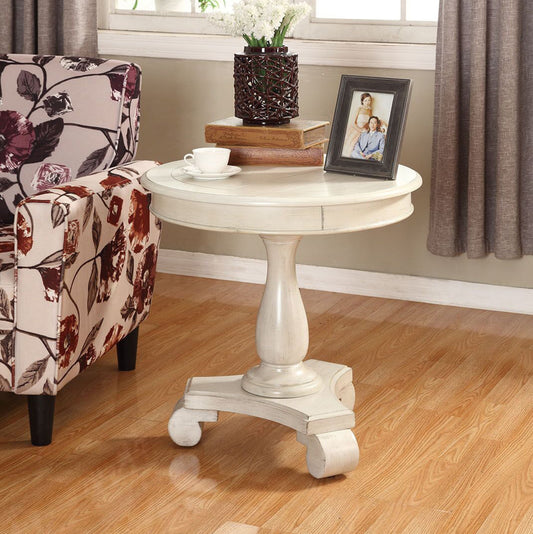 Antique white round pedestal side table with carved details for living room accent