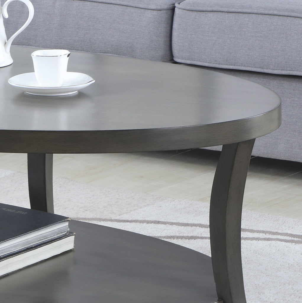 Dark gray oval coffee table with curved legs and a lower shelf