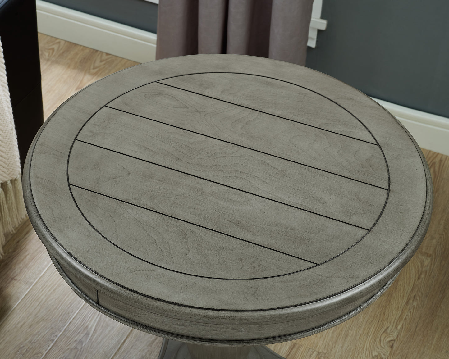 Rustic grey wood round accent table with slatted top and dark metal accents