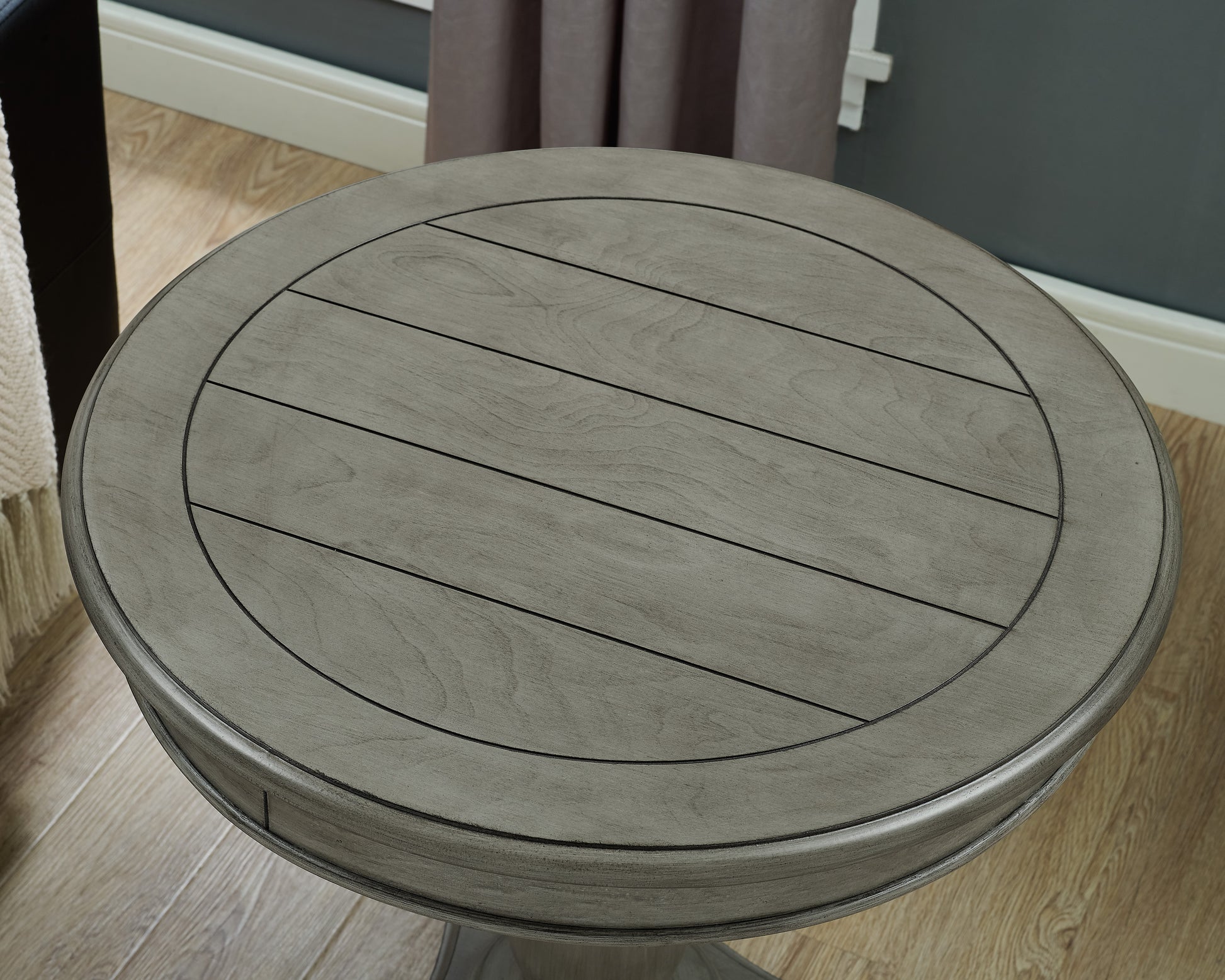 Rustic grey wood round accent table with slatted top and dark metal accents