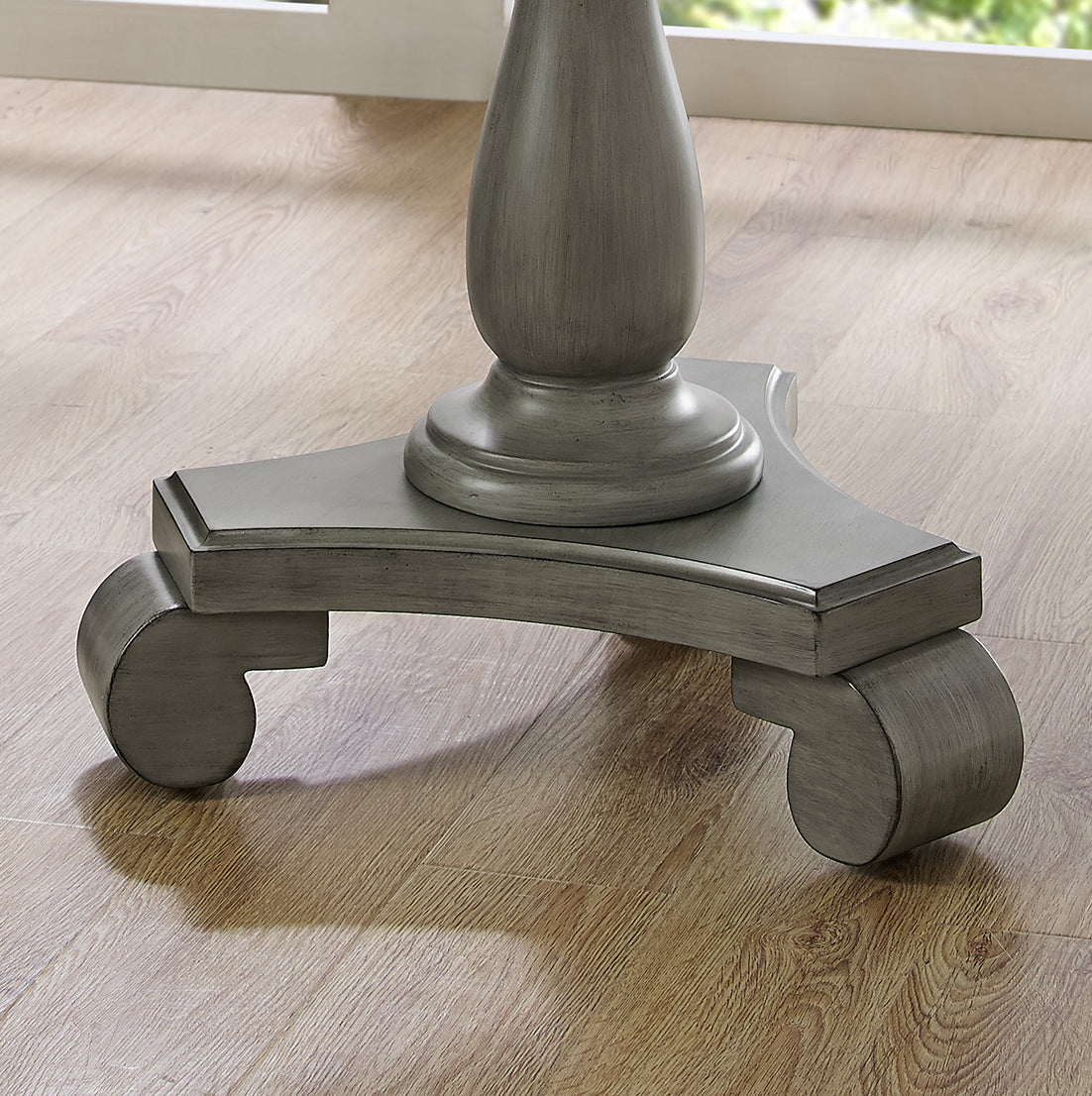 Grey distressed wood pedestal base with scrolled feet for a classic dining table