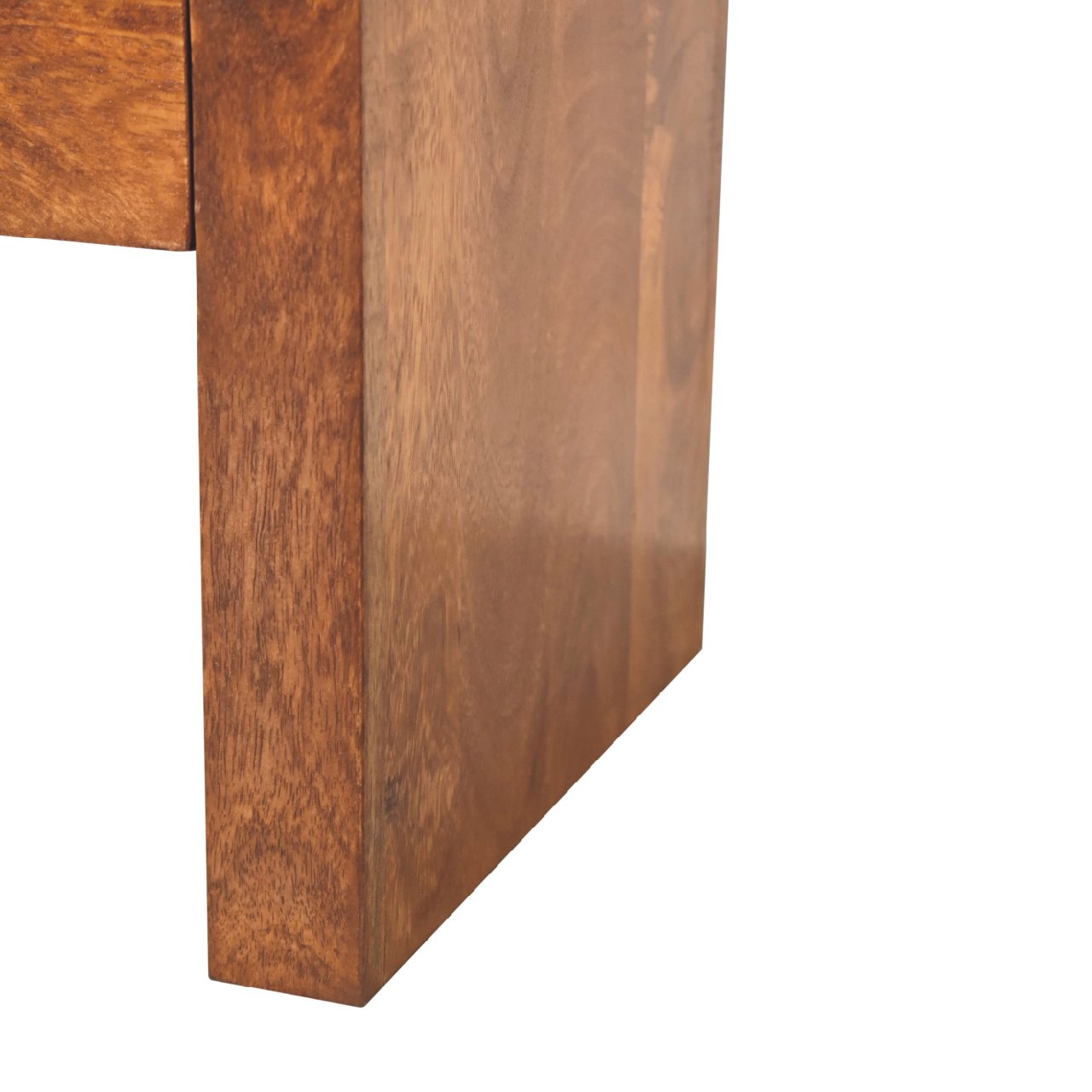 Closeup of a solid wood table leg in a warm medium brown tone