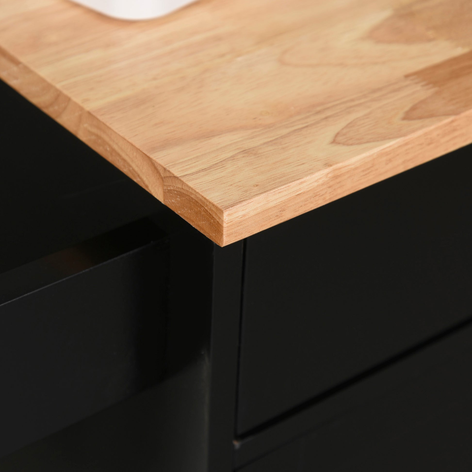 Light wood grain countertop edge detail on a matte black cabinet
