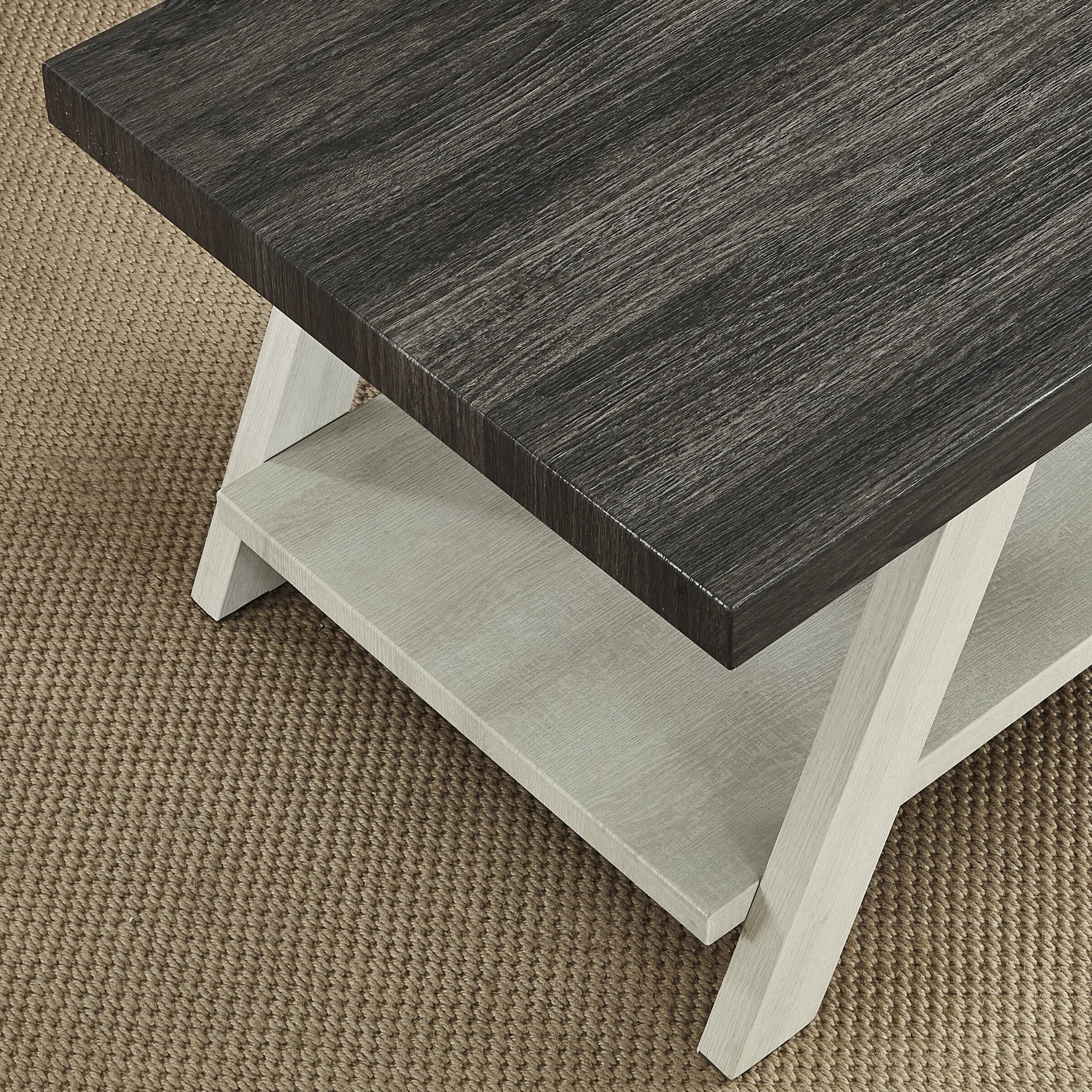 Modern coffee table with dark wood top light wood base and lower shelf