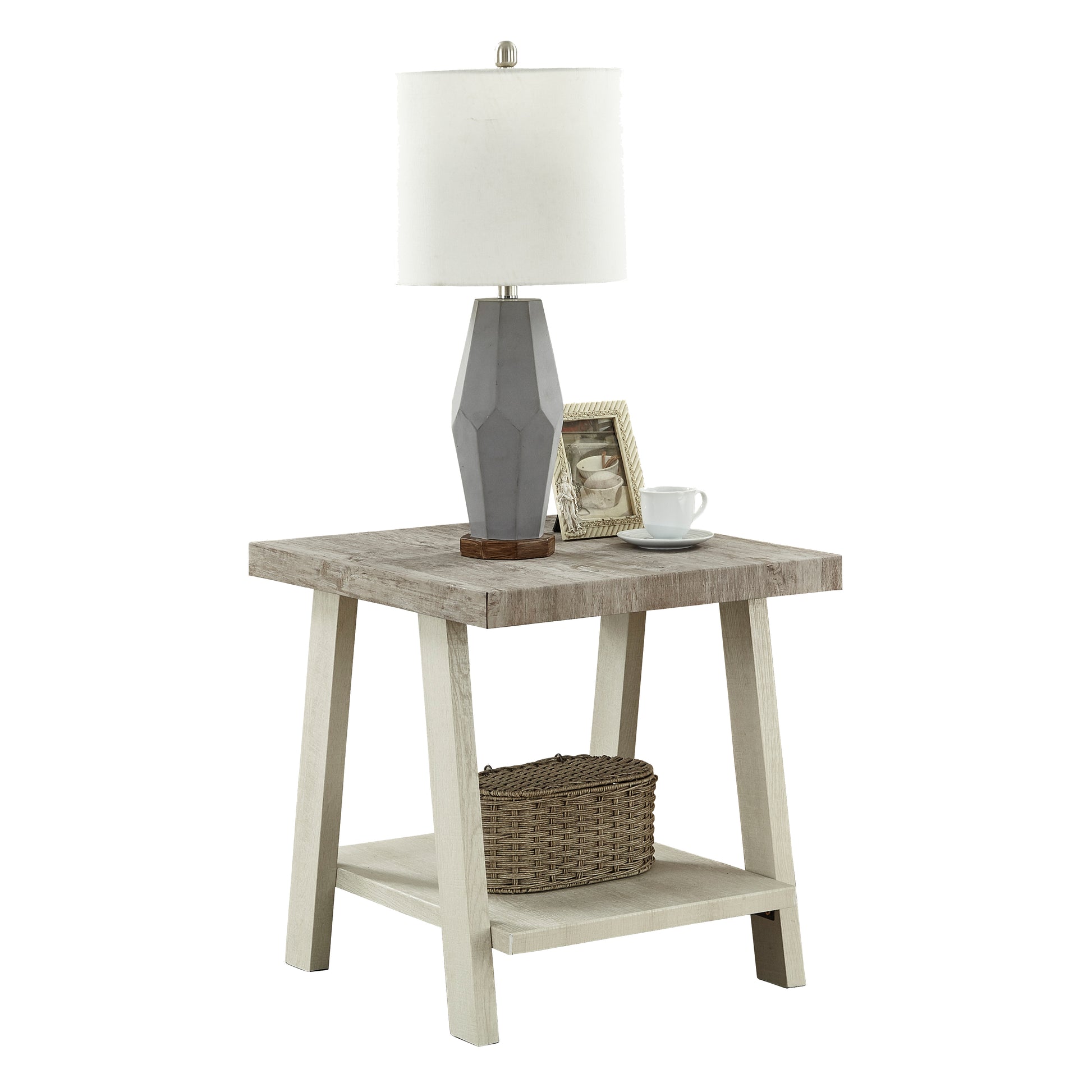 Distressed wood end table with geometric gray lamp framed picture and white mug