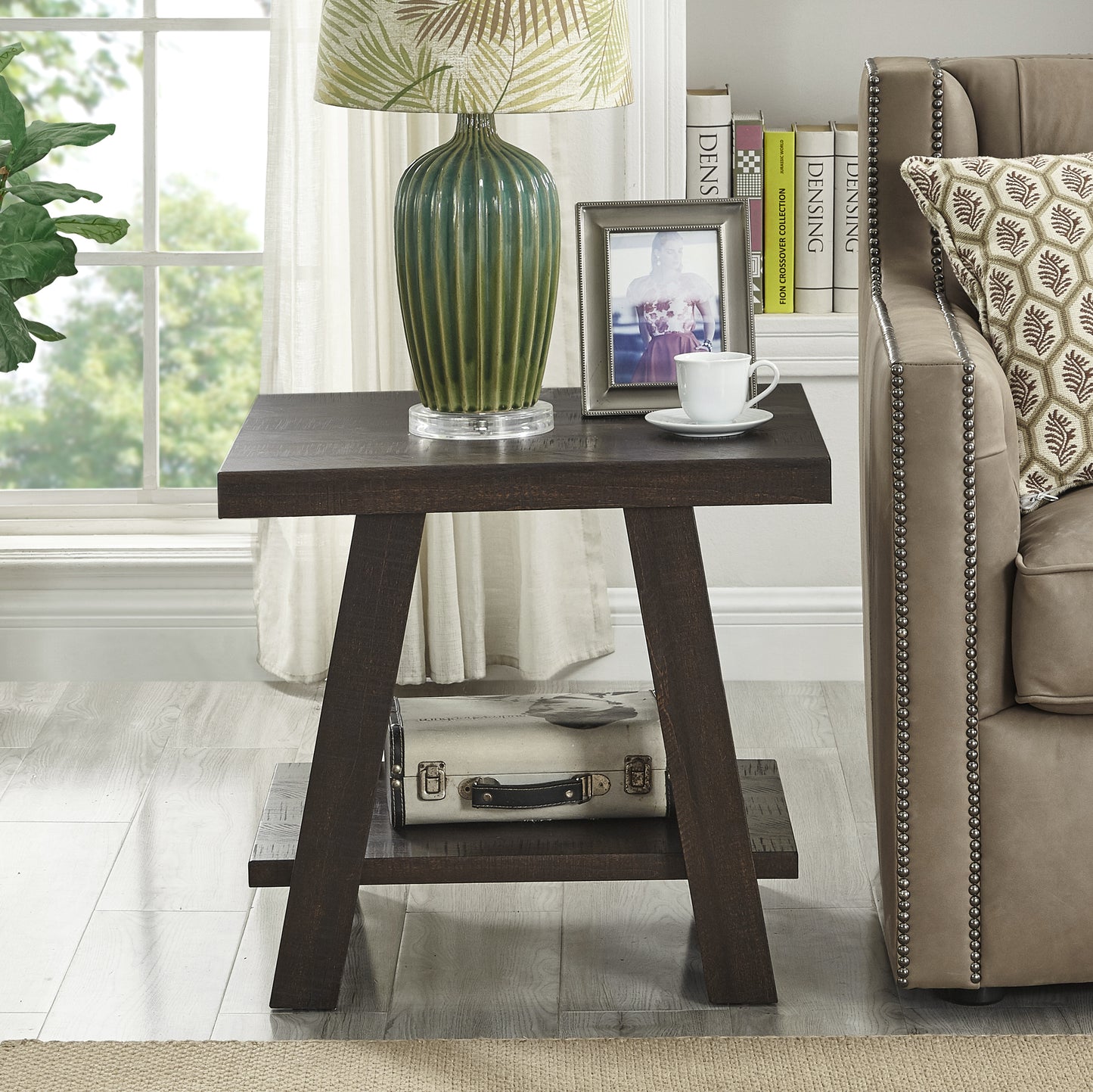 Dark wood accent table with tiered shelves and a decorative suitcase