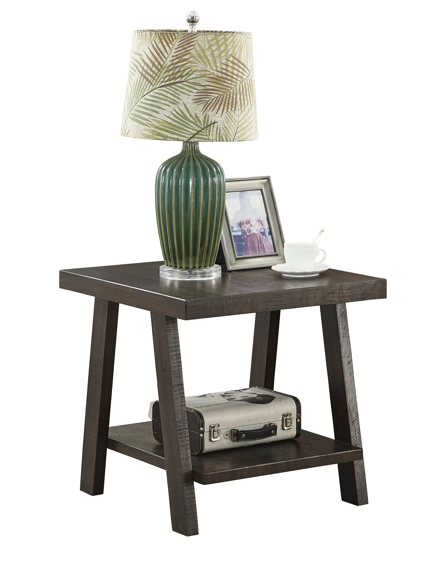 Dark wood end table with a fluted green ceramic lamp silver picture frame and white teacup