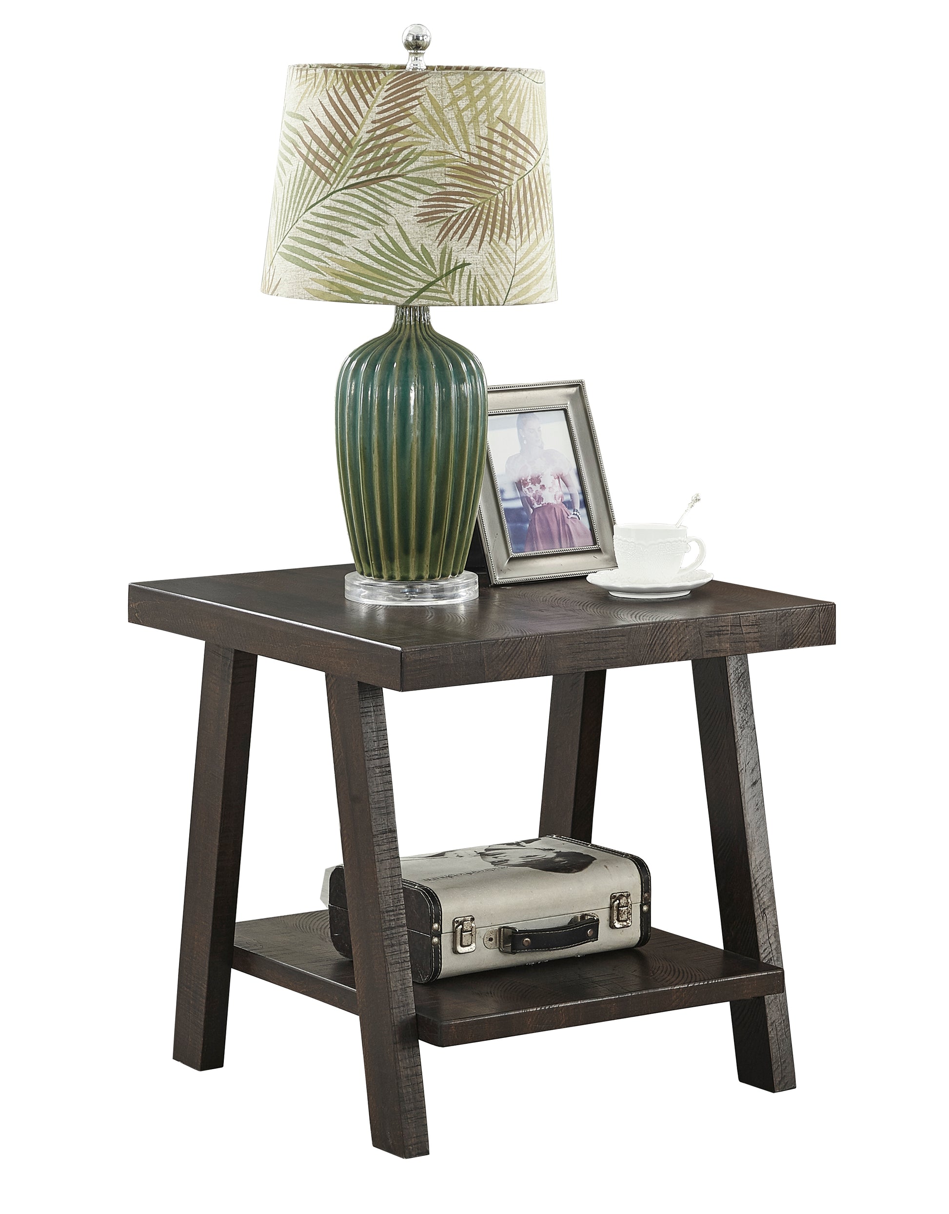 Dark wood end table with a fluted green ceramic lamp silver picture frame and white teacup
