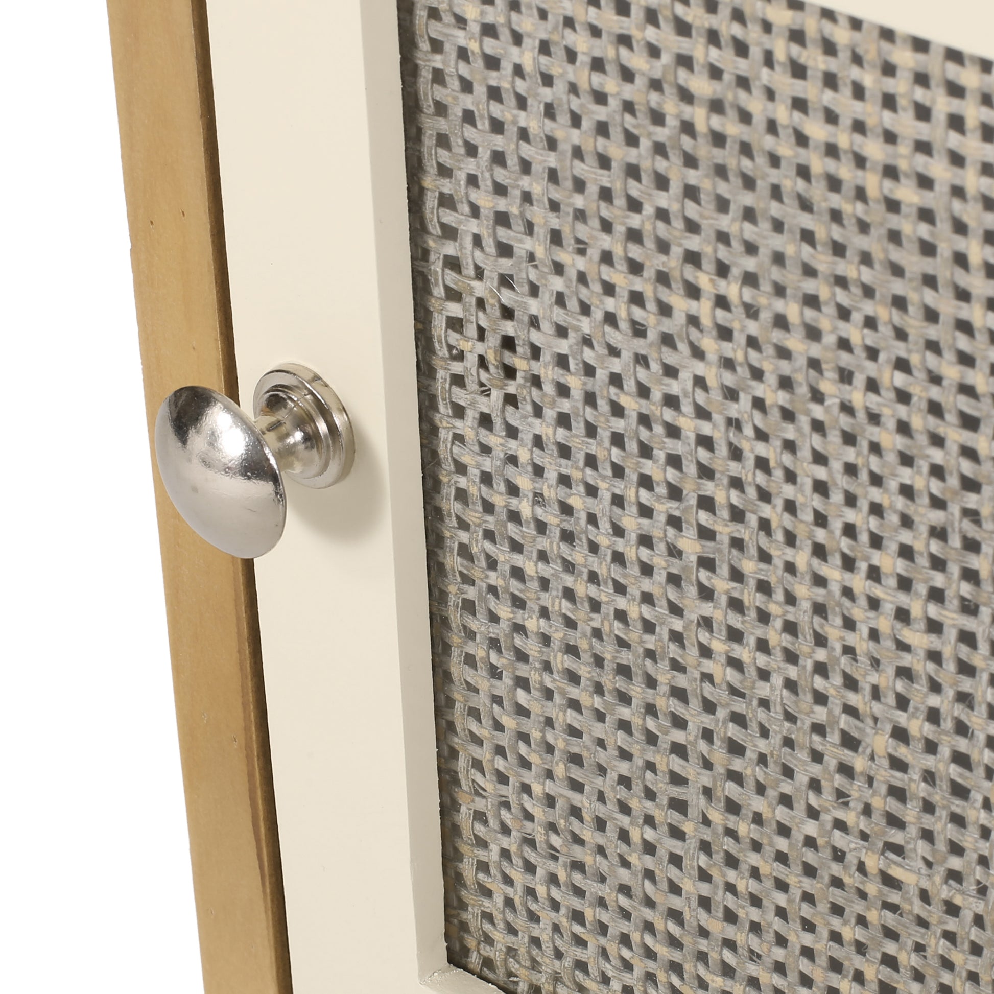 Closeup of a vintage rattan weave cabinet door with a silver knob