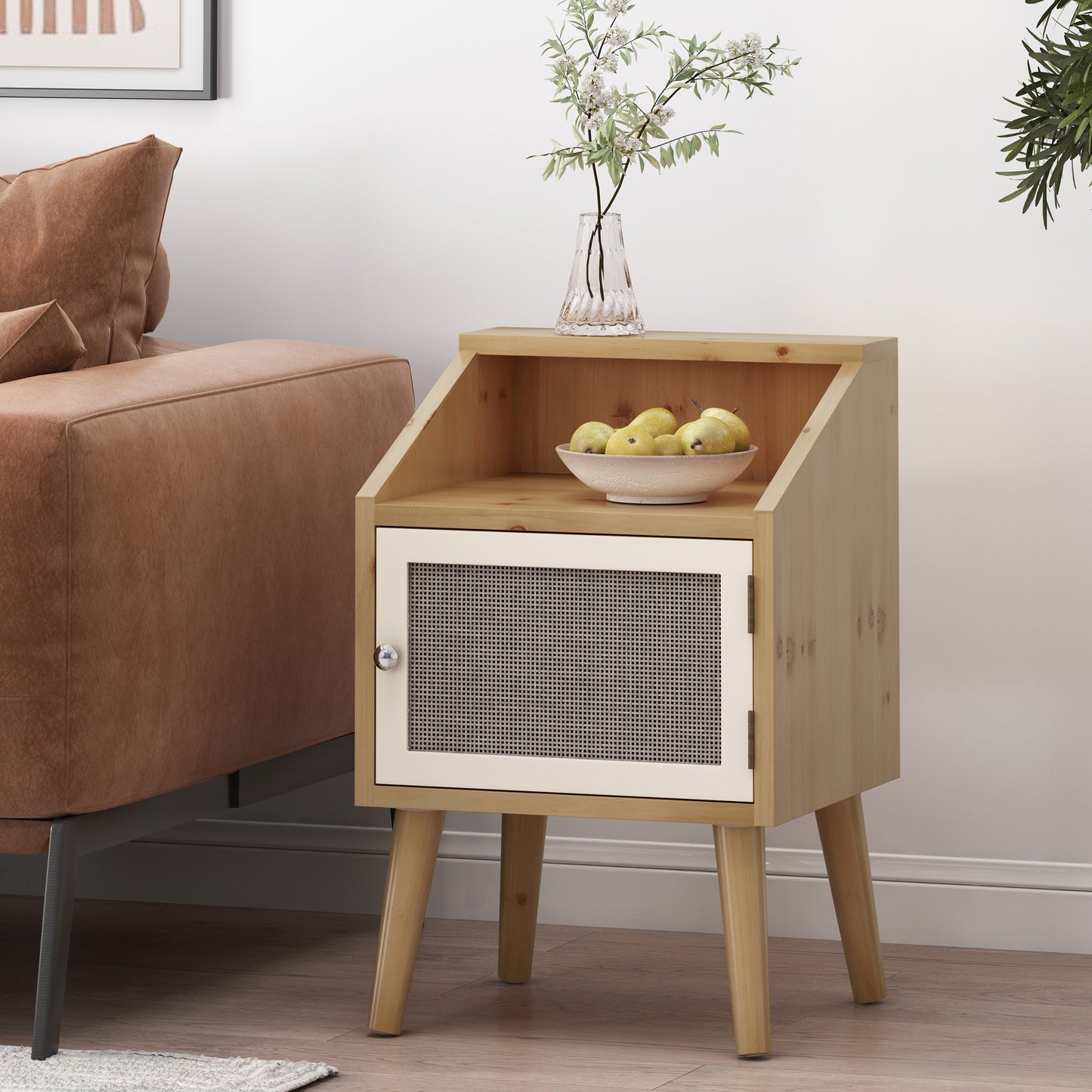 Light wood accent table with a woven cane door cabinet and open shelf displaying fruit