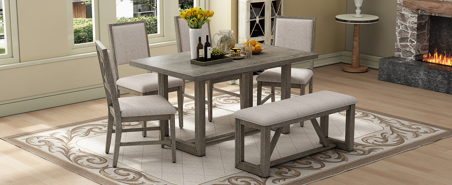 Grey washed wood dining table with four chairs and bench