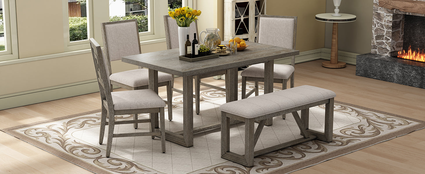 Grey washed wood dining table with four chairs and bench