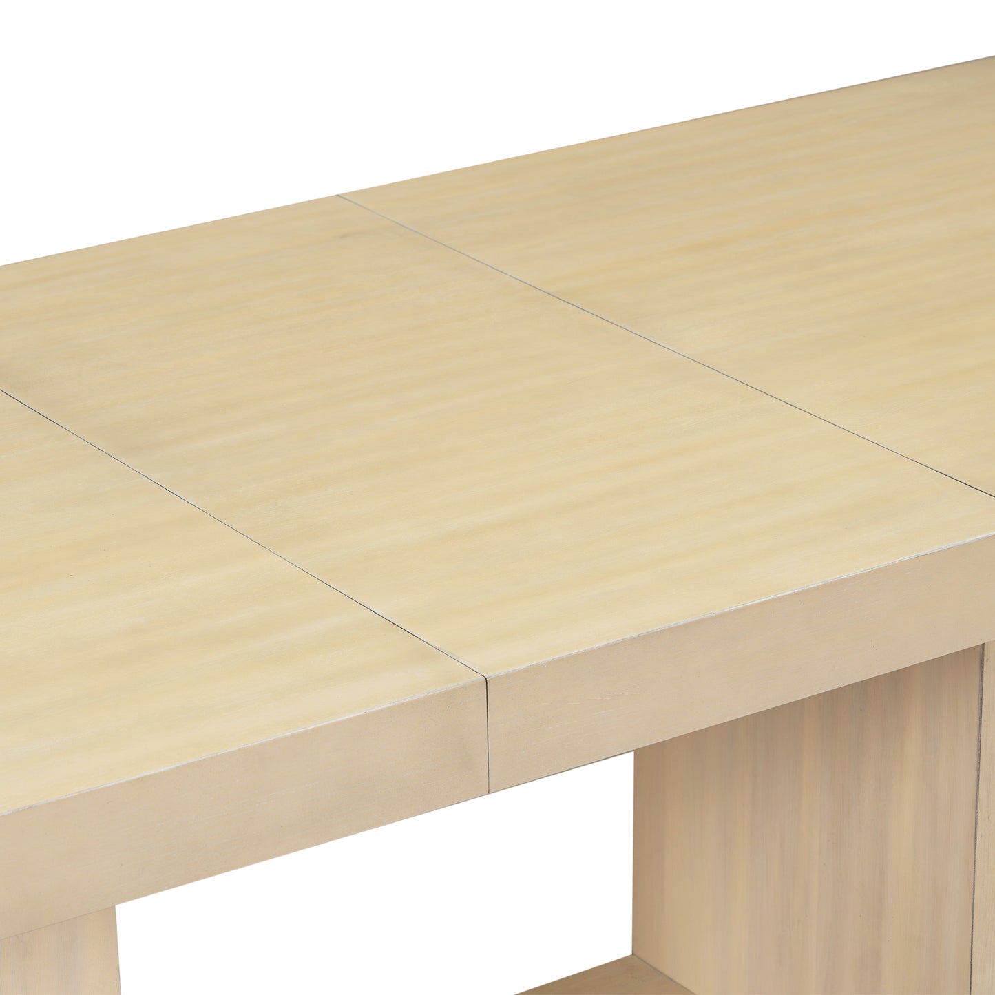 Closeup of a light oak dining table surface with visible wood grain and seam lines