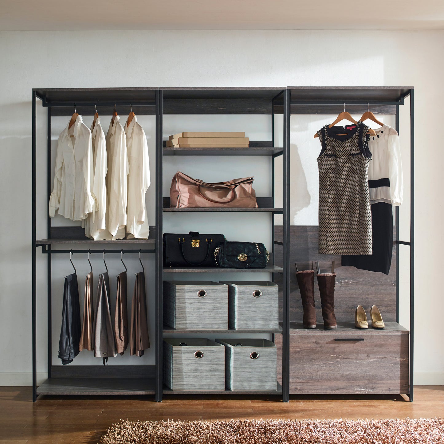 Four white linen shirts with ruffled cuffs hanging on a rack
