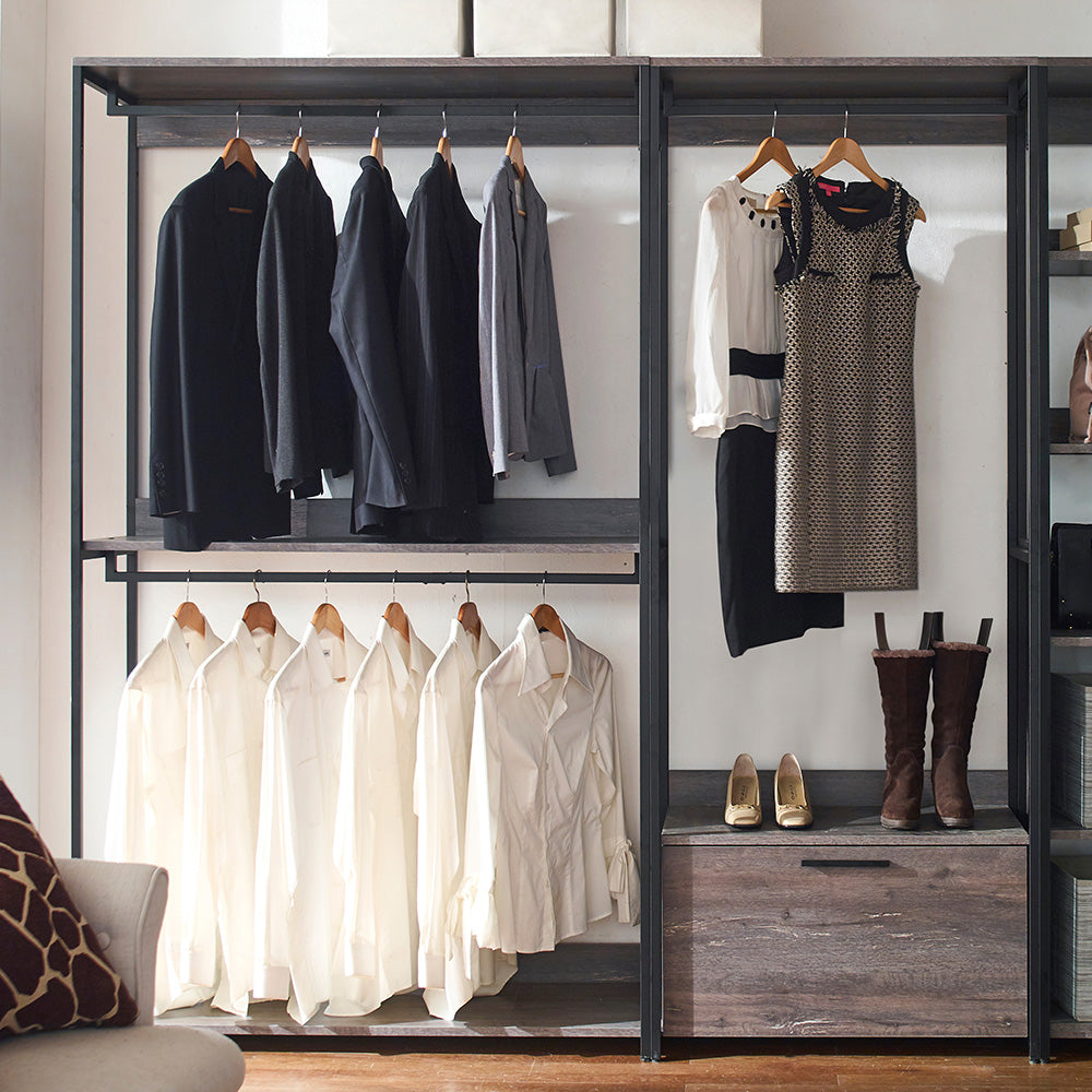 Black mens blazer hanging on a rack with four other suits