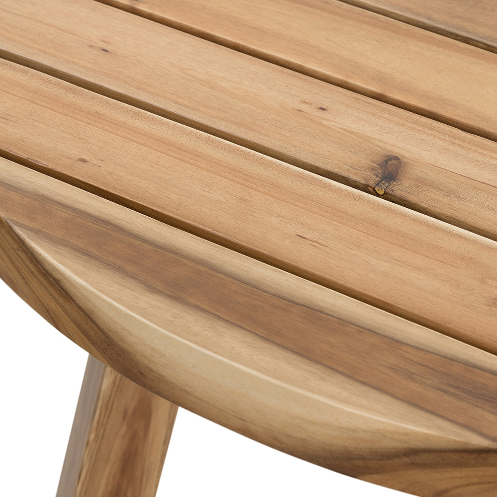 Closeup of a rustic acacia wood outdoor table with slatted top and curved edge
