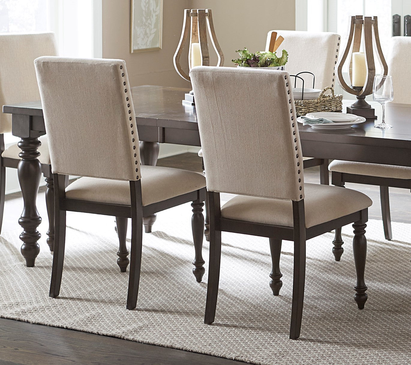 Beige upholstered dining chair with nailhead trim