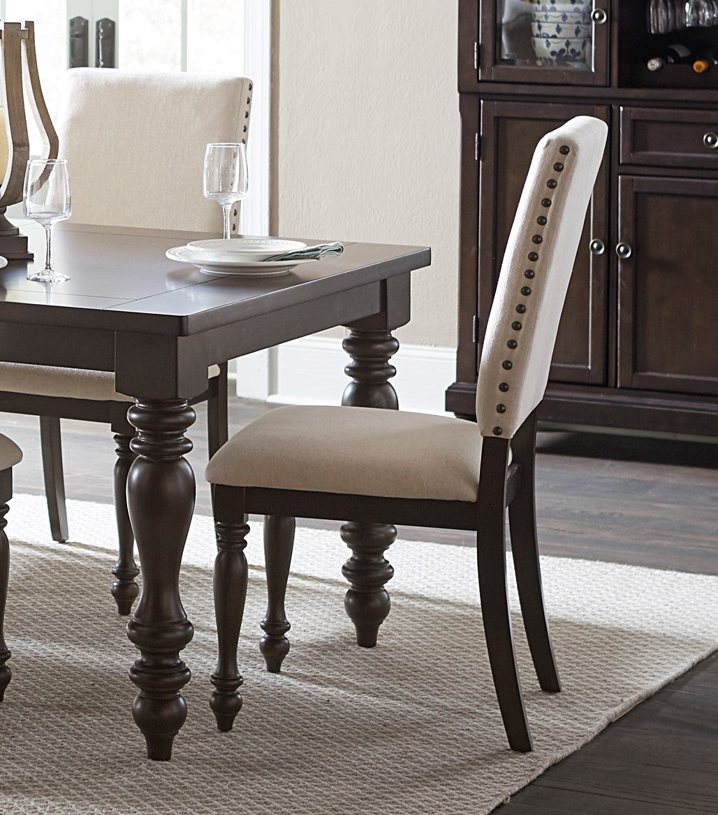 Tufted beige upholstered dining chair with nailhead trim detail