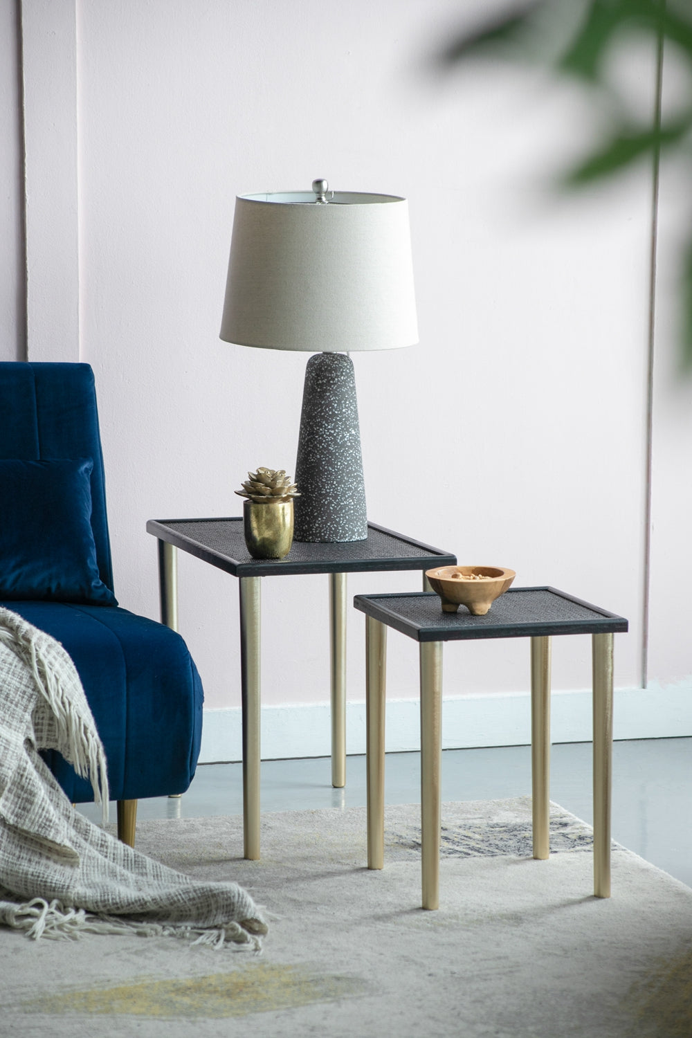 Modern grey speckled table lamp with a textured conical base and a neutral shade