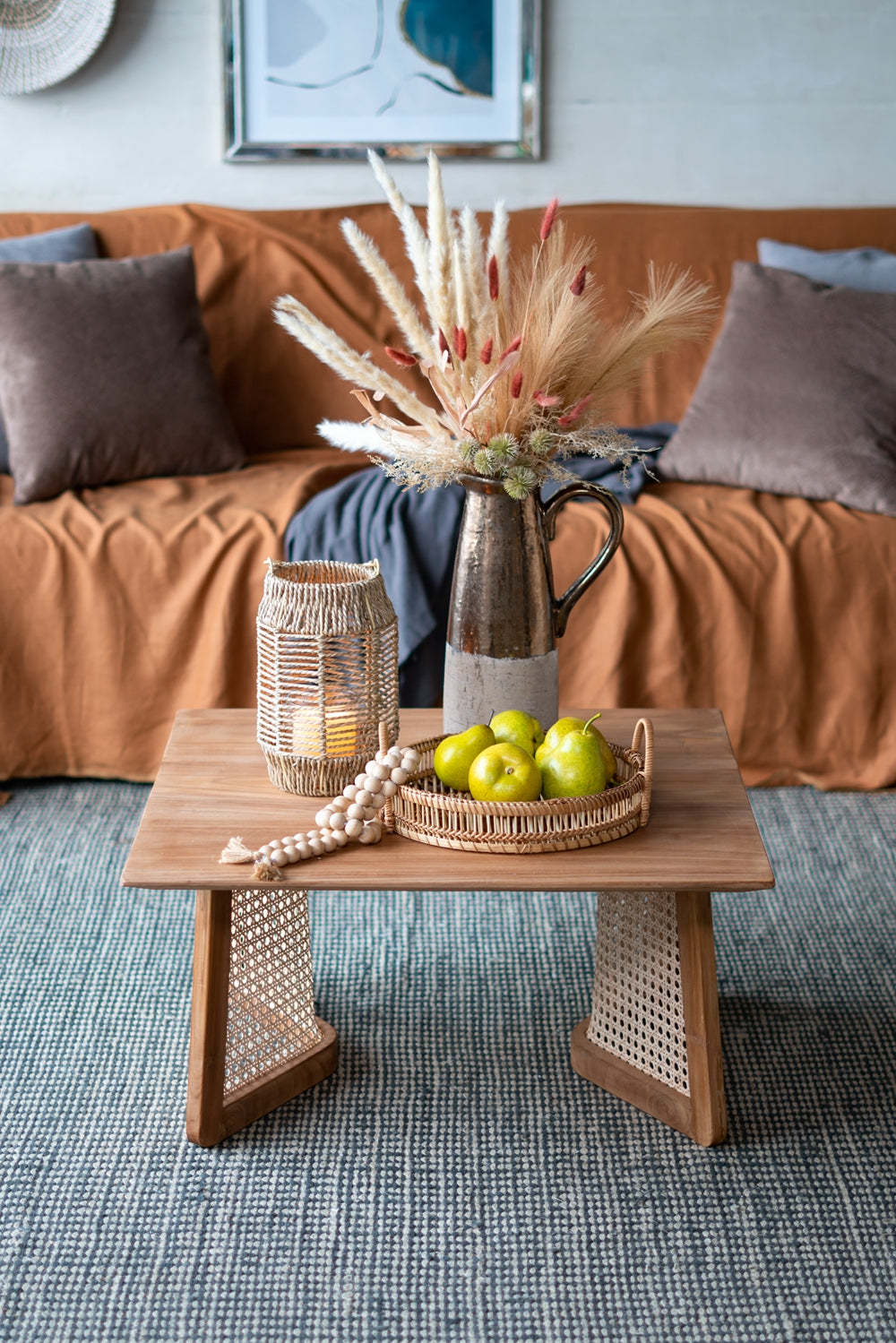 Rustic wooden coffee table with decorative elements including green pears in a woven tray