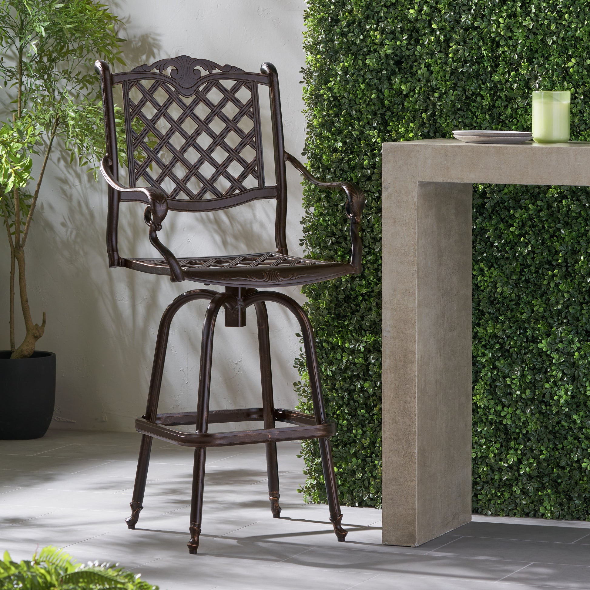 Ornate bronze outdoor bar stool with diamond lattice back and swivel seat