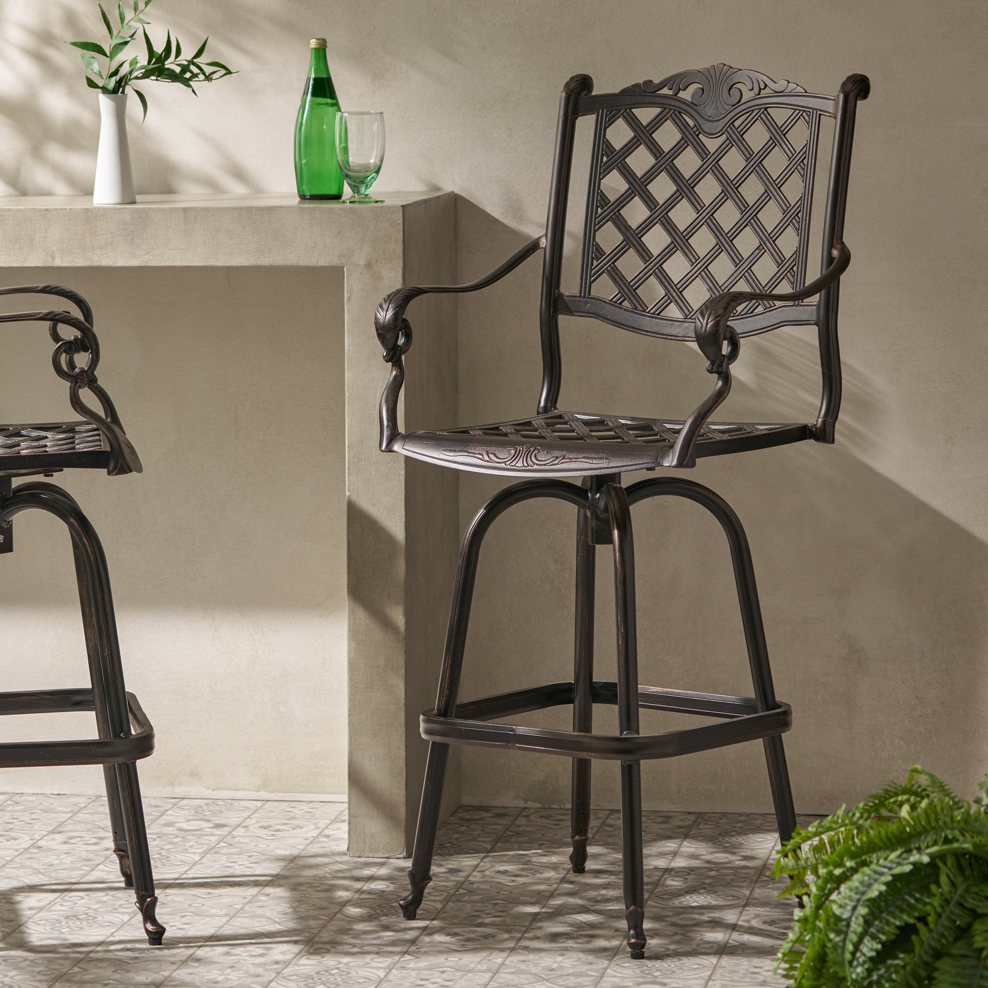 Ornate dark brown metal outdoor bar stool with lattice backrest