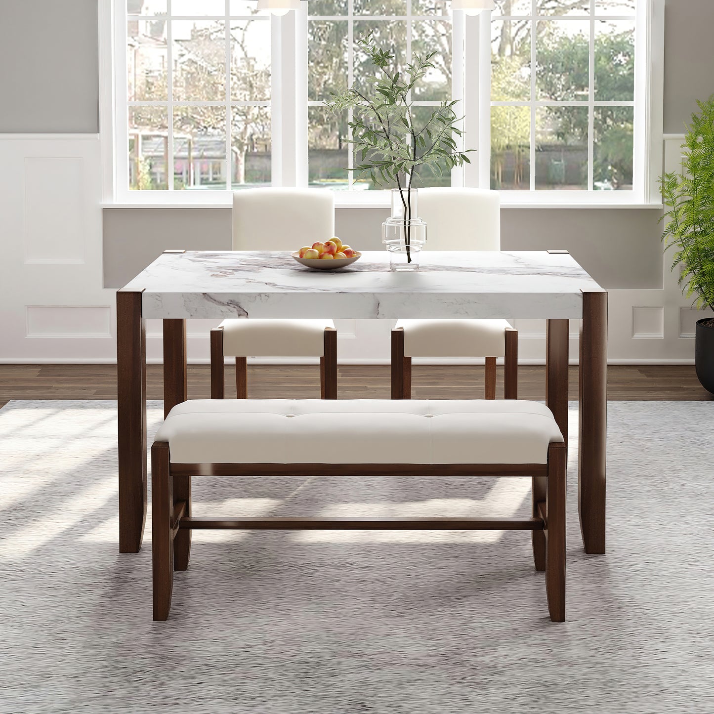 Marble top dining table with dark wood legs and white upholstered bench