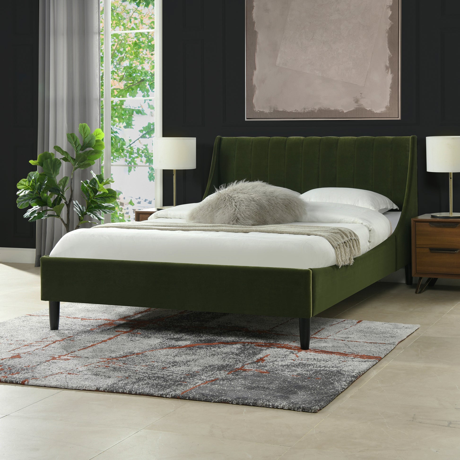 Green velvet platform bed with channel tufting on the headboard