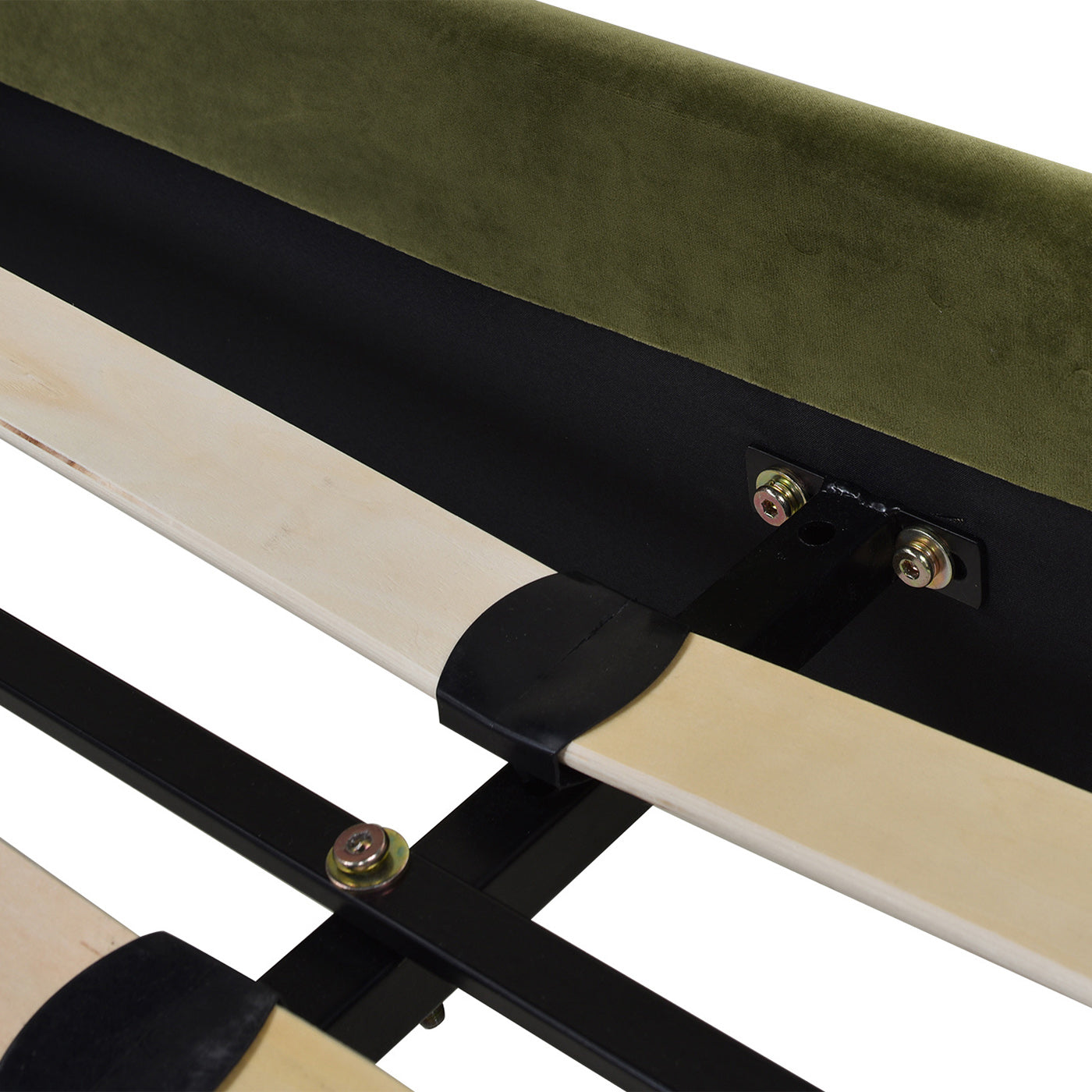 Closeup of green velvet headboard attachment to black metal bed frame