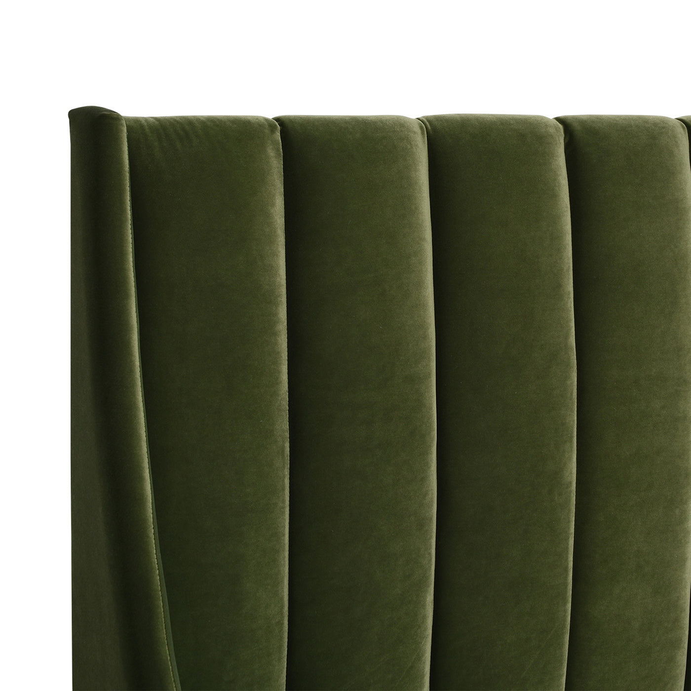 Dark green velvet channeltufted headboard detail for a luxurious bedroom