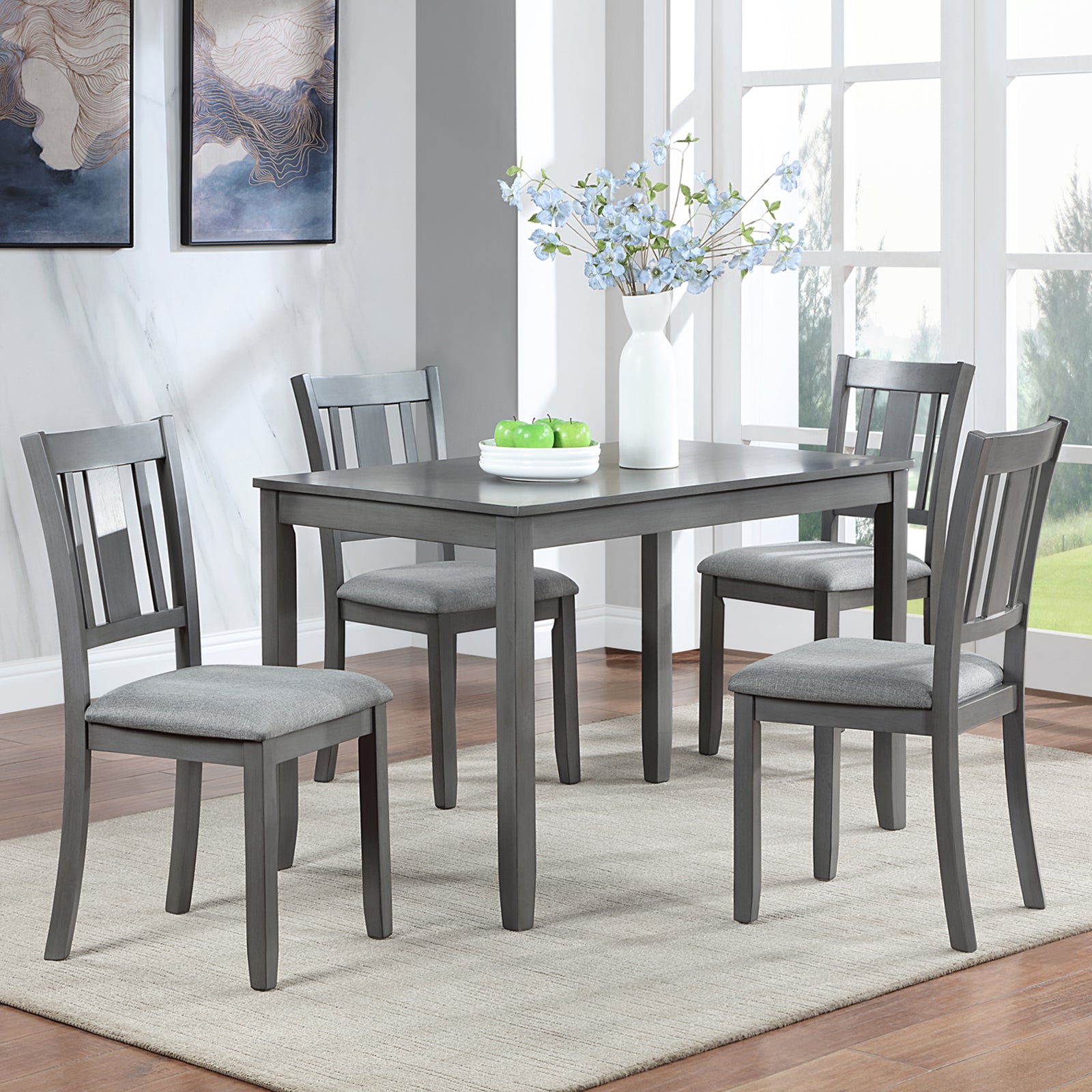 Gray wood dining table set with four upholstered chairs