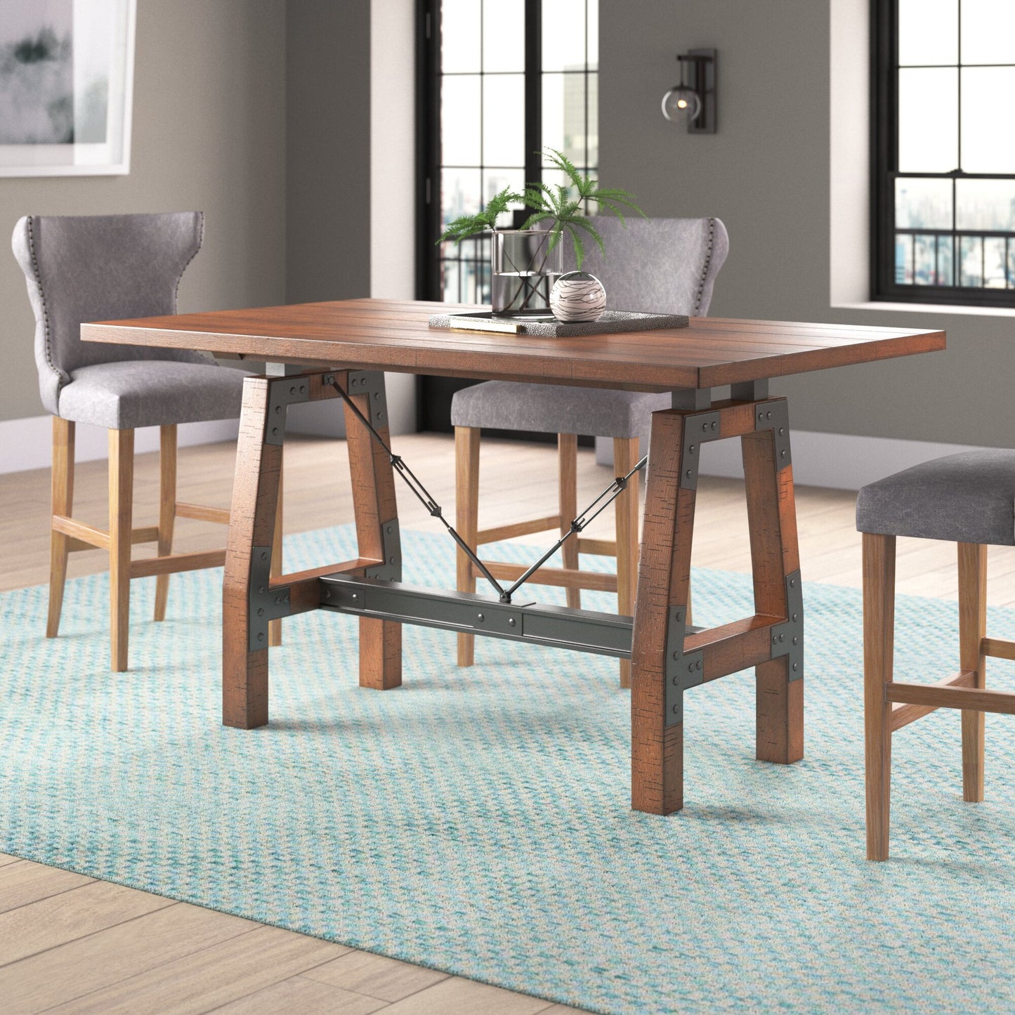 Rustic brown wood dining table with industrial metal accents and gray upholstered stools