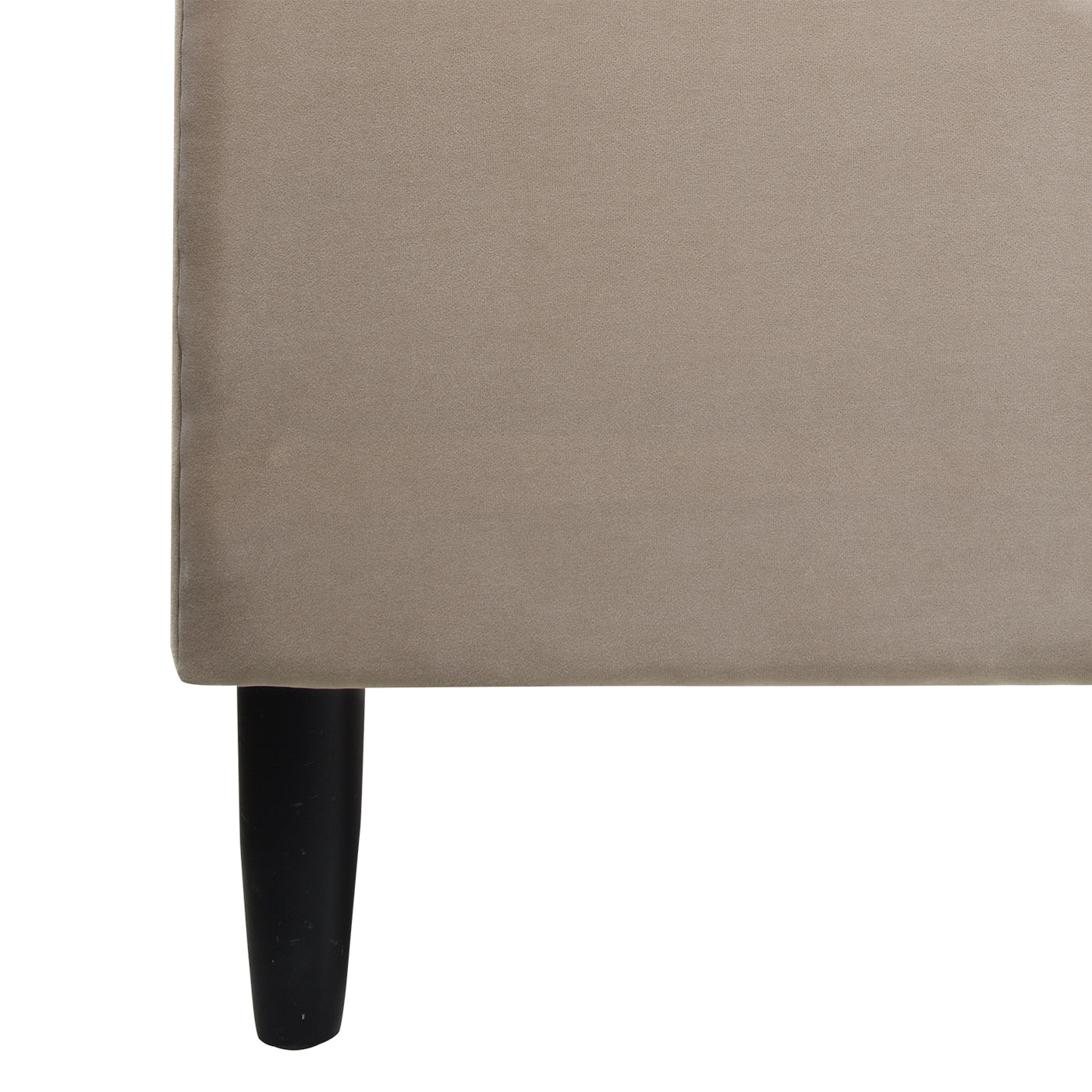Beige upholstered sofa corner with dark tapered legs